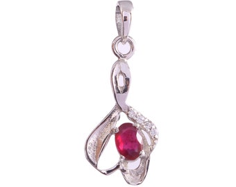 May include: A silver pendant with a red gemstone and clear cubic zirconia stones. The pendant is shaped like a stylized heart.