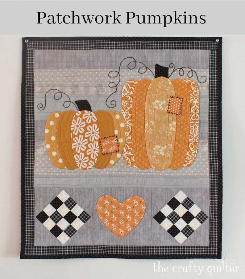 May include: A patchwork quilt featuring two orange pumpkins with different patterns, a heart, and two black and white checkered squares. The quilt is framed with a black and white checkered border. The text "Patchwork Pumpkins" is at the top of the image and "the crafty quilter" is at the bottom.