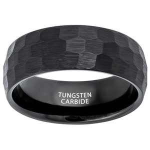 May include: Black tungsten carbide ring with a hammered finish. The ring is engraved with the words "Tungsten Carbide".