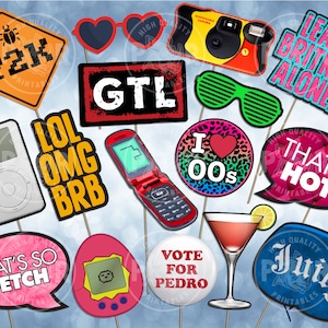 May include: A collection of photo booth props with various designs and text. Includes props with the phrases "Y2K", "GTL", "LOL OMG BRB", "That's So Fetch", "Leave Britney Alone!", and "That's Hot". Other props include a flip phone, heart-shaped sunglasses, and a disposable camera.