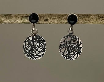 Sterling silver drop earrings with black onyx and pattern.