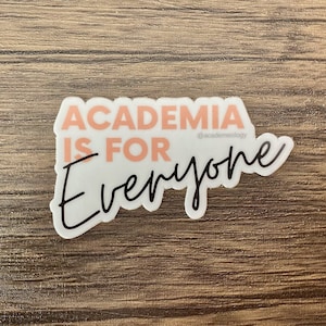 May include: White sticker with the text "Academia is for everyone" in black and pink lettering. The text "@academeology" is in smaller black lettering below the main text.