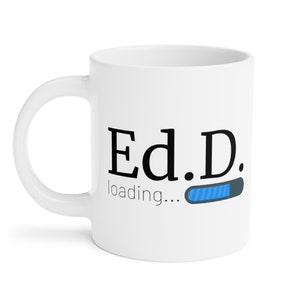 May include: White ceramic coffee mug with the text "Ed.D. loading..." and a blue progress bar.