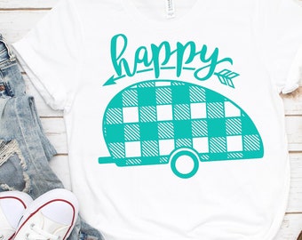 May include: White t-shirt with a teal camper graphic and the word "happy" with an arrow on either side. The camper is patterned with teal and white buffalo plaid.