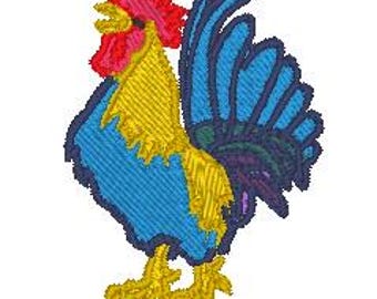 May include: Embroidered rooster design in vibrant colors. The rooster features a red comb and wattle, a yellow beak and legs, a blue body, and a detailed blue and purple tail. The design is on a white background.