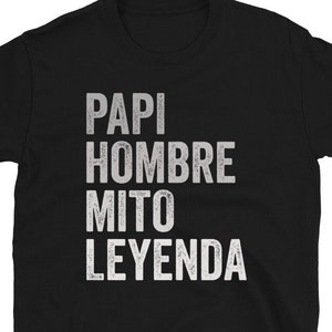 May include: Black t-shirt with white text that reads "Papi Hombre Mito Leyenda".