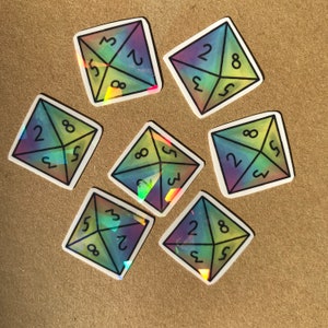 May include: Eight iridescent holographic stickers shaped like dice with the numbers 2, 3, 5, and 8 on each face.