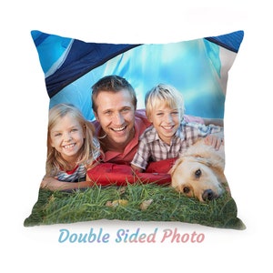 May include: Square pillow featuring a family portrait inside a blue tent. The image shows a smiling man, a girl, a boy, and a golden retriever dog. The pillow has the text "Double Sided Photo" in a gradient color.