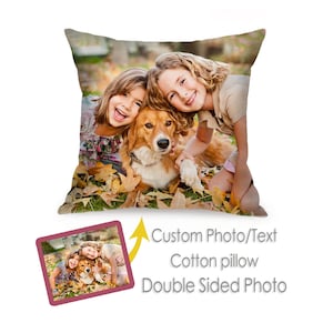 May include: A double-sided cotton cushion displaying a custom photo of two smiling children and a dog amongst autumn leaves. The cushion has a white background and the text "Custom Photo/Text" is visible.