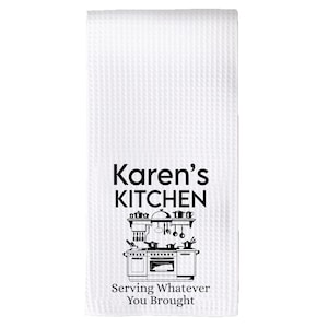 May include: White kitchen towel with black text that reads "Karen's Kitchen" and a black and white illustration of a kitchen stove with the text "Serving Whatever You Brought".