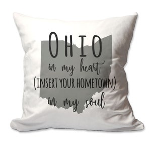 May include: White throw pillow with a gray outline of the state of Ohio. The text reads "Ohio in my heart (INSERT YOUR HOMETOWN) in my soul".
