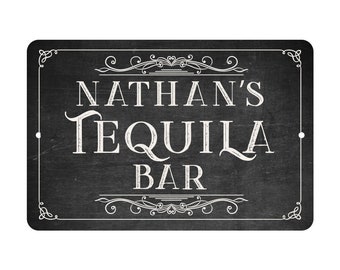 May include: Black chalkboard sign with white text that reads "Nathan's Tequila Bar" with decorative flourishes around the text.