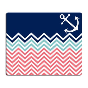 May include: A navy blue and white anchor graphic on a background of pink and blue chevron stripes.