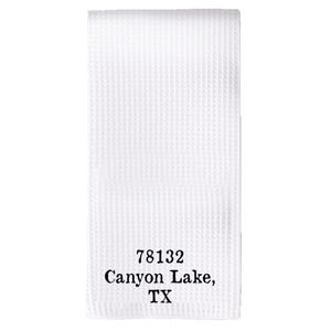 May include: White waffle weave kitchen towel with black embroidered text that reads "78132 Canyon Lake, TX".