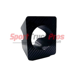 May include: Black carbon fiber gauge pod with a round hole in the center.