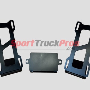 May include: Three black metal brackets with a rectangular shape and multiple holes. The brackets are designed for mounting and securing objects.