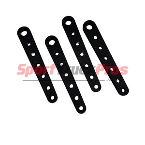 May include: Four black plastic straps with multiple holes. The straps are approximately 2 inches long and have a rounded end.