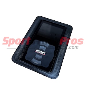 May include: Black Air Lift Performance air suspension control unit with a digital display and a round button with the Air Lift Performance logo.