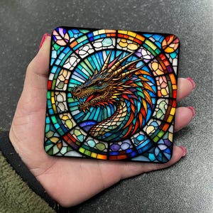 May include: A colourful stained glass design featuring a dragon's head with a blue, green, yellow, orange, and red colour scheme.