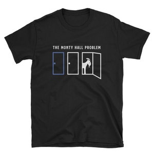 May include: Black t-shirt with white text that reads "THE MONTY HALL PROBLEM". The text is above a graphic of three doors, one with a blue circle and two with goats behind them.