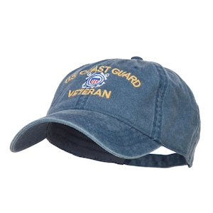 May include: A blue denim baseball cap with the embroidered text "US Coast Guard Veteran" and the Coast Guard emblem in yellow.