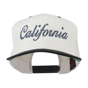 May include: A white baseball cap with the word "California" embroidered in navy blue script across the front. The cap has a black brim with a green underside and a black adjustable strap.