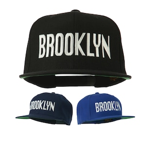 May include: Three baseball caps with the word "BROOKLYN" embroidered on the front. One cap is black, one is navy blue, and one is royal blue.