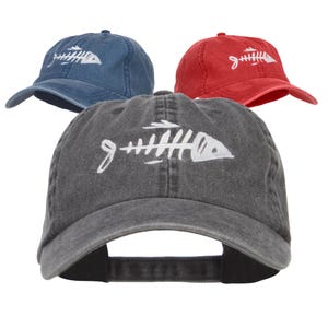 May include: Three baseball caps with a white fishbone design. One cap is blue, one is red, and one is gray.