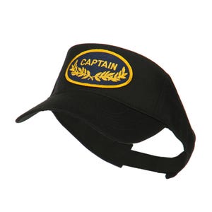 May include: Black visor with a curved brim and an adjustable strap. The visor features a patch with the word "CAPTAIN" in white lettering on a blue background, surrounded by gold laurel leaves.