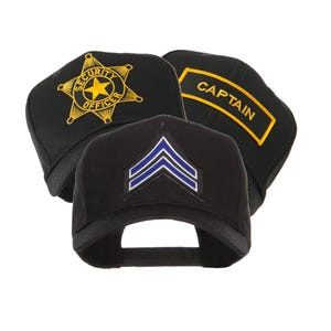 May include: Three black baseball caps with different embroidered designs. One cap features a gold star and the words "SECURITY OFFICER". Another has the word "CAPTAIN" in gold. The third cap displays blue and white chevrons.
