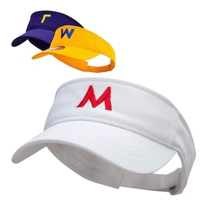 May include: Three sun visors with different coloured fabric and embroidered letters. The first visor is navy blue with a yellow "L" embroidered on the front. The second visor is yellow with a blue "W" embroidered on the front. The third visor is white with a red "M" embroidered on the front.