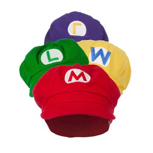 May include: Four colorful baseball caps in red, green, yellow, and purple. Each cap features a white letter: "M", "L", "W", and "Γ". The caps are arranged in a circular pattern, with the red cap in the foreground.