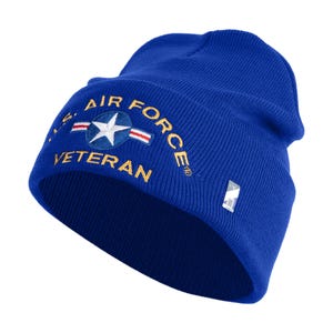 May include: A royal blue knit beanie featuring the text "U.S. Air Force Veteran" embroidered in gold. The design includes a white star within a blue circle, with red and white stripes. A small silver tag is attached.
