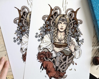 May include: An art print featuring a blonde person with braided hair wearing a headband and white shirt, holding a bowl. The illustration includes a red fox, blue flowers, and brown antlers, with a stylized knotwork background design.