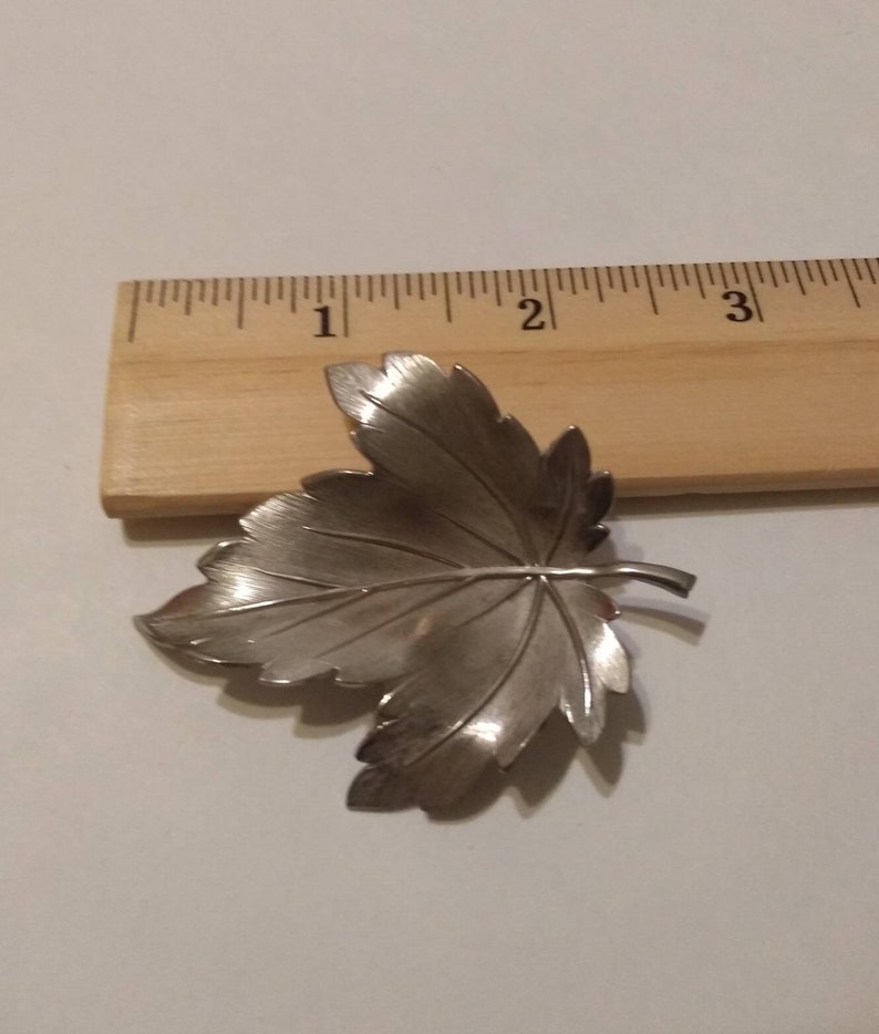 Silver-tone leaf brooch signed Giovann maple leaf