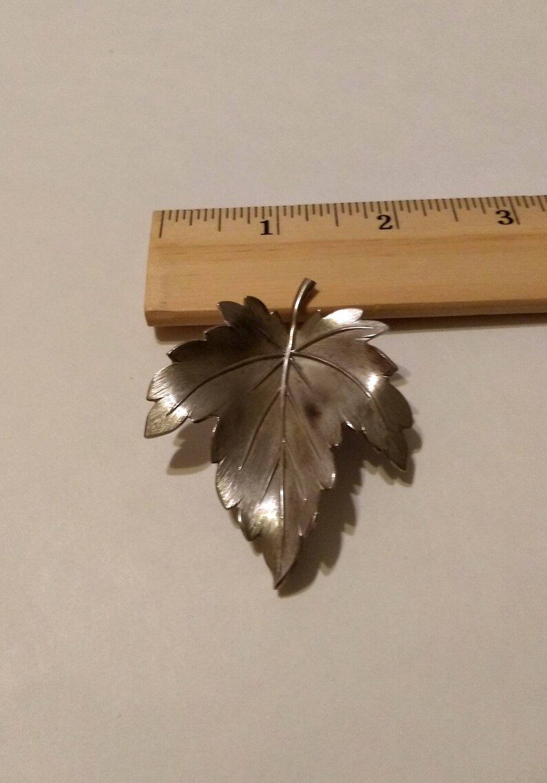 Silver-tone leaf brooch signed Giovann maple leaf