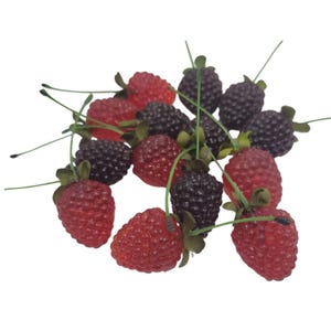 May include: A collection of artificial berries, including red strawberries and dark purple blackberries. Each berry has a green stem and leaf detail. The berries are scattered against a white background, suggesting a decorative or craft theme.