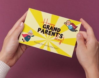 May include: A yellow card with a red and black graphic that says "Happy Grandparent's Day!" with a cartoon image of a superhero grandmother and grandfather. The text at the bottom of the card says "Thanks for being the best!"