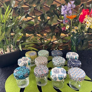 May include: A set of three ceramic mugs with a speckled, matte finish. Each mug features a different color: light blue, cream, and gray. The mugs have a simple, modern design, perfect for coffee or tea.