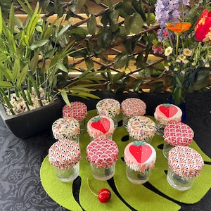 May include: A set of three ceramic mugs with a speckled, matte finish. The mugs are in shades of blue, green, and white. Each mug has a rounded handle and a slightly flared rim. The mugs are stacked on top of each other.