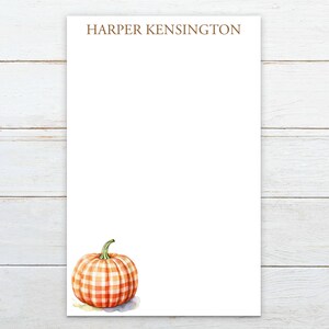 May include: Personalized stationery featuring the name "HARPER KENSINGTON" at the top and a watercolor illustration of a gingham pumpkin in the bottom right corner.