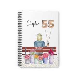 May include: A spiral-bound notebook with a white cover featuring a watercolor illustration. The design includes the text "Chapter 55" with gold balloon numbers, a person sitting on a bench, and colorful flowers in buckets. The name "Melissa" is also visible.