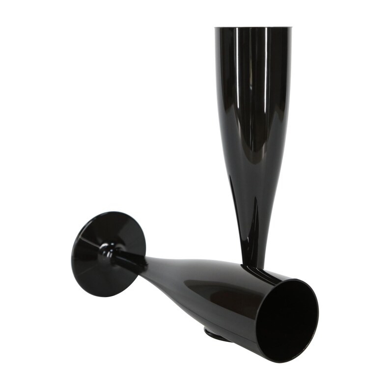 May include: Two glossy black champagne flutes with a tall, slender bowl and a circular base. One flute stands upright while the other is positioned horizontally, showcasing the smooth, reflective surface and the elongated, tapered design.