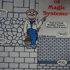 May include: A book cover titled The Magic of Magic Systems by Millie Beacham. It features a cartoon man in a white jacket and blue overalls holding a bucket with a rabbit. The background displays various textures like stone, brick, and block patterns.