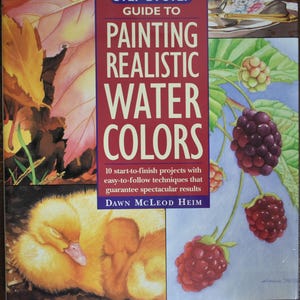 May include: A book cover titled "Guide to Painting Realistic Water Colors" with a red banner. The cover features watercolor paintings of leaves, berries, and a sleeping duckling. The author's name is Dawn McLeod Heim.