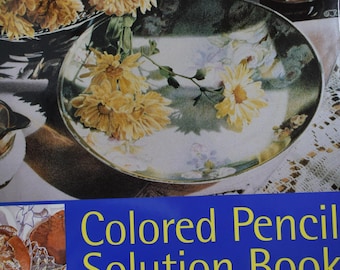 Libro de soluciones con lápices de colores