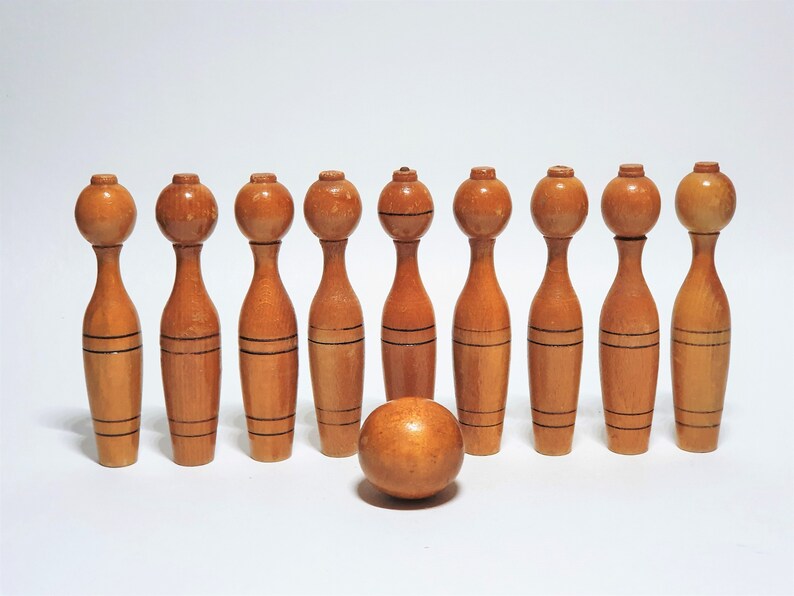 antique skittles game with wooden pins and iron bumbers antique skittles game with wooden pins and iron bumbers