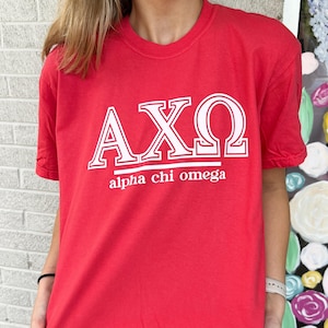 May include: Red t-shirt with white lettering that says "AXO alpha chi omega"