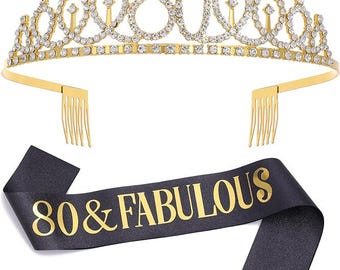 May include: Gold tiara with rhinestones and the number 80 on top. A black satin sash with gold lettering reads "80 & FABULOUS".
