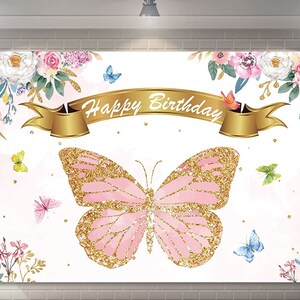 May include: A white backdrop with a pink and gold glitter butterfly, surrounded by watercolor flowers and a gold banner with the text "Happy Birthday".